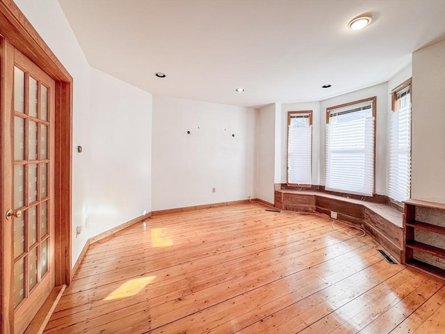 unfurnished room featuring light hardwood / wood-style floors