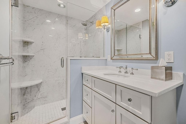 full bathroom featuring a marble finish shower, vanity, and recessed lighting