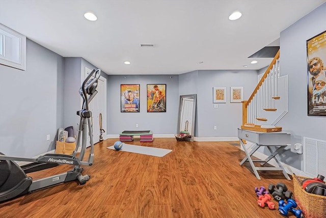 exercise area with visible vents, baseboards, wood finished floors, and recessed lighting