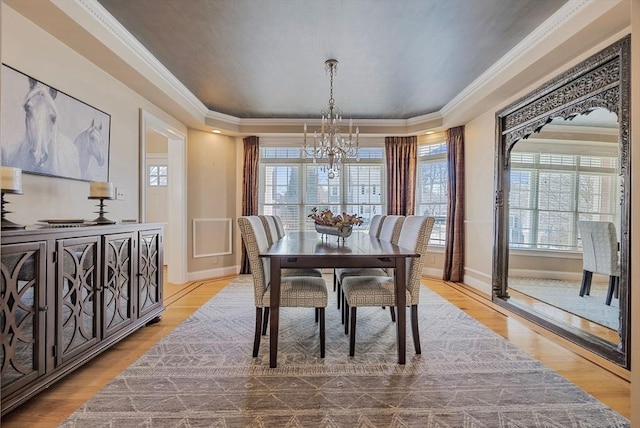 dining area featuring plenty of natural light, a chandelier, and wood finished floors