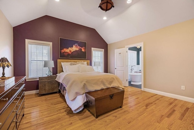 bedroom with lofted ceiling, light wood-style floors, and multiple windows