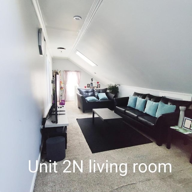 living area featuring lofted ceiling with skylight and carpet floors