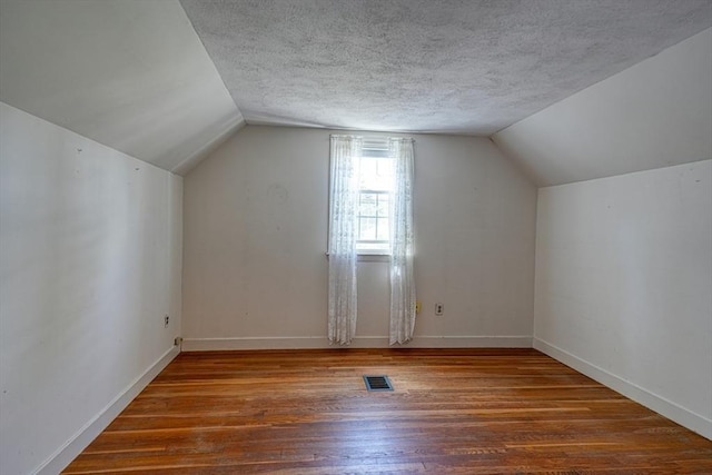 22 Willis Lake Dr, Sudbury, MA 01776 - bonus room with hardwood / wood-style flooring, vaulted ceiling, and a textured ceiling