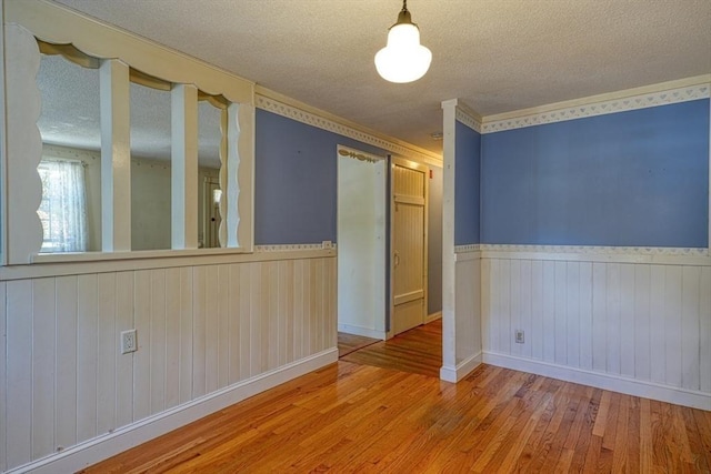 22 Willis Lake Dr, Sudbury, MA 01776 - spare room with a wainscoted wall, a textured ceiling, wood finished floors, and wood walls