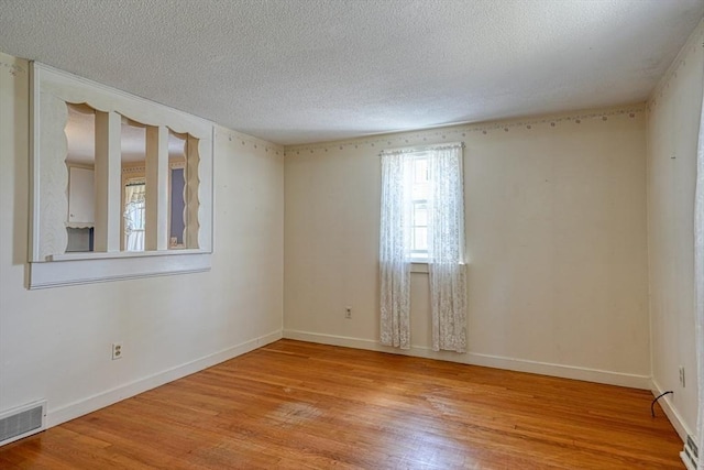 22 Willis Lake Dr, Sudbury, MA 01776 - spare room with light wood-type flooring and a textured ceiling