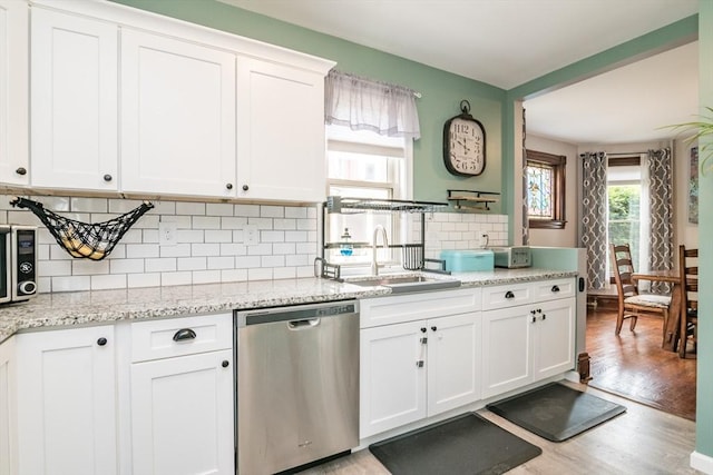 61 Fairfield Ave, Holyoke, MA 01040 - kitchen featuring dishwasher, a sink, light wood-style floors, white cabinets, and backsplash