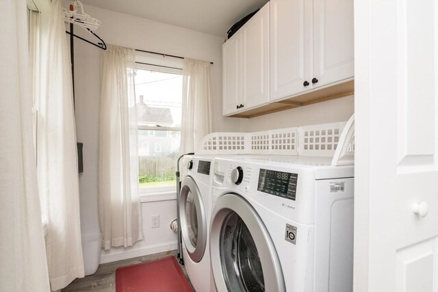 61 Fairfield Ave, Holyoke, MA 01040 - laundry area with washer and dryer, plenty of natural light, cabinet space, and baseboards