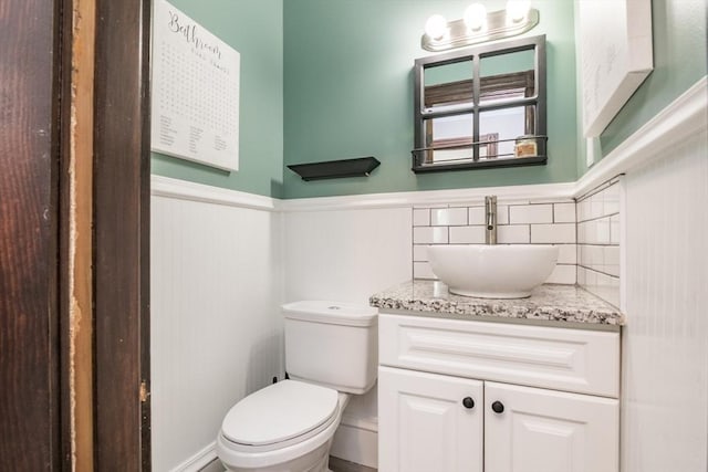 61 Fairfield Ave, Holyoke, MA 01040 - bathroom with vanity, toilet, a wainscoted wall, and backsplash