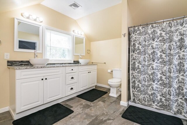 61 Fairfield Ave, Holyoke, MA 01040 - full bath featuring vaulted ceiling, double vanity, toilet, baseboards, and a shower with curtain