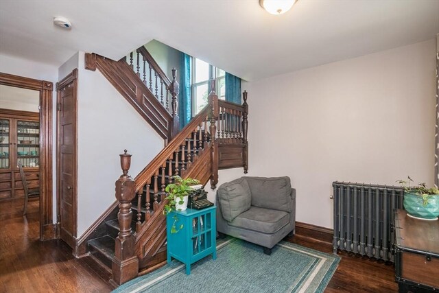 61 Fairfield Ave, Holyoke, MA 01040 - staircase with wood finished floors, radiator, and baseboards