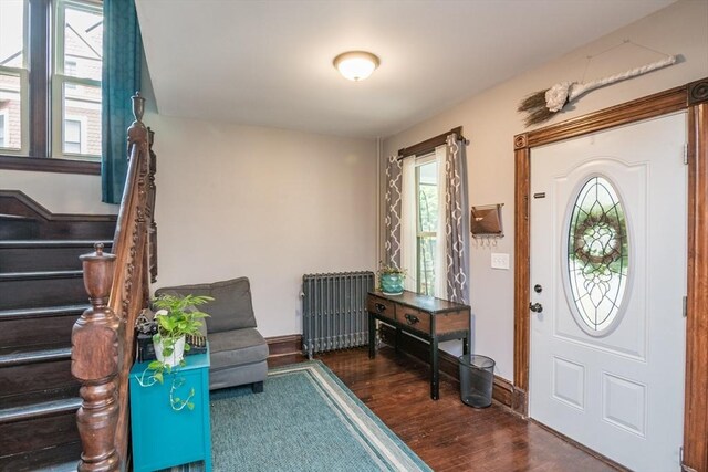 61 Fairfield Ave, Holyoke, MA 01040 - foyer with radiator, wood finished floors, plenty of natural light, and stairway