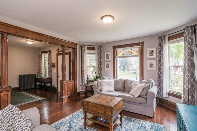 61 Fairfield Ave, Holyoke, MA 01040 - living area featuring decorative columns, wood finished floors, and baseboards