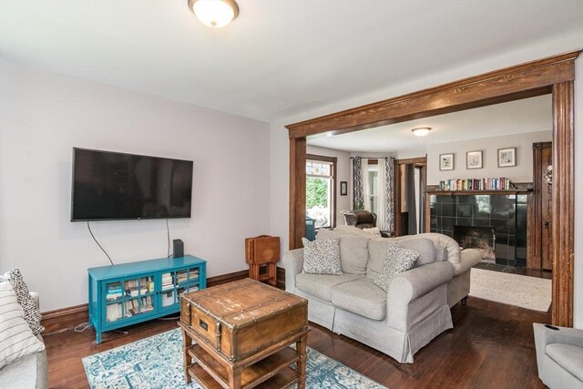 61 Fairfield Ave, Holyoke, MA 01040 - living room with a tile fireplace, wood finished floors, and baseboards
