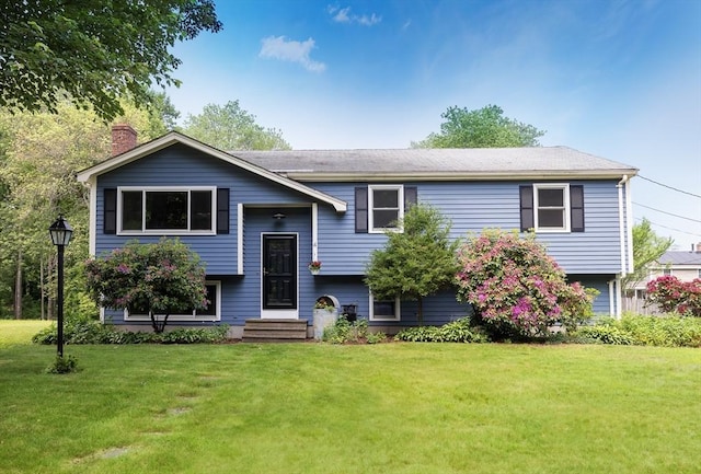 4 Charles River Rd, Medway, MA 02053 - split foyer home with a front yard and a chimney