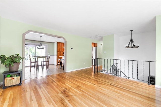 4 Charles River Rd, Medway, MA 02053 - unfurnished room with arched walkways, light wood-type flooring, and a chandelier