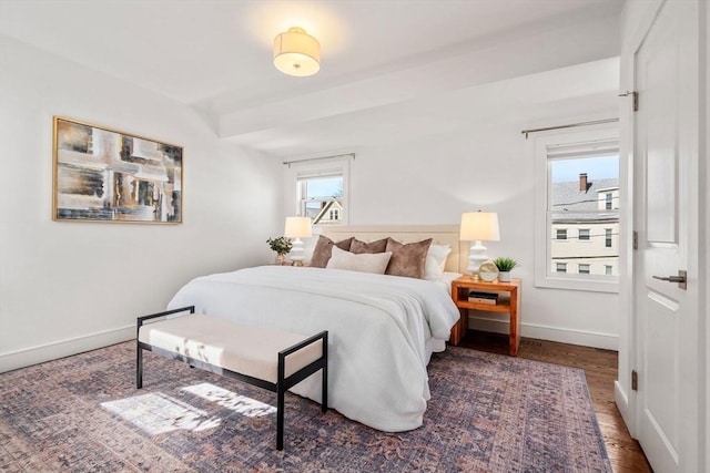 bedroom with wood finished floors and baseboards