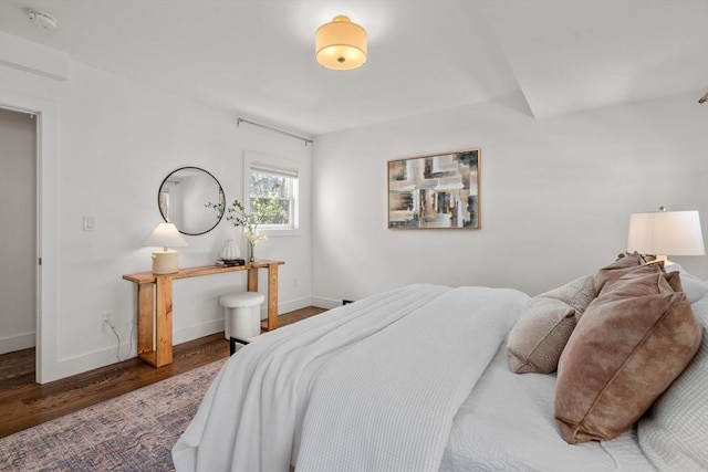 bedroom with wood finished floors and baseboards