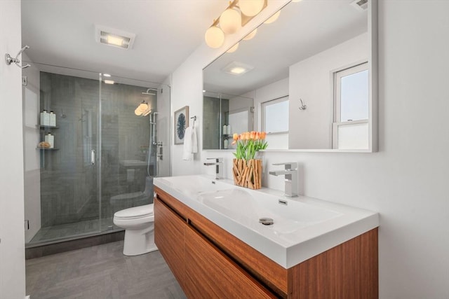 full bath featuring visible vents, double vanity, a stall shower, a sink, and toilet