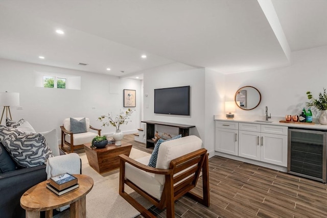 living area featuring wet bar, wine cooler, recessed lighting, and wood tiled floor