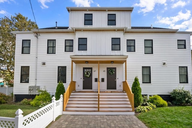 view of front of home with board and batten siding and fence