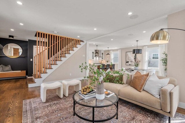 living room featuring stairway, recessed lighting, baseboards, and wood finished floors