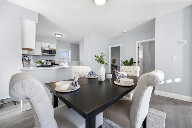 dining area with dark wood-type flooring