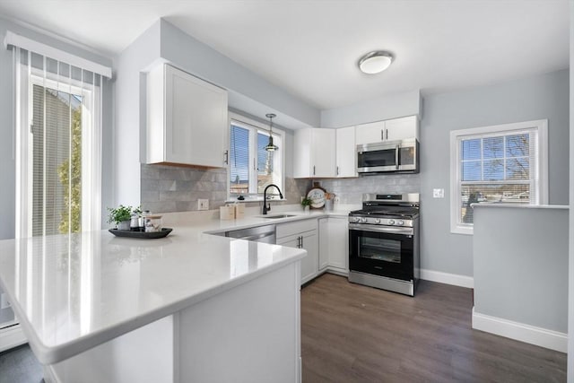 kitchen with sink, appliances with stainless steel finishes, and white cabinetry