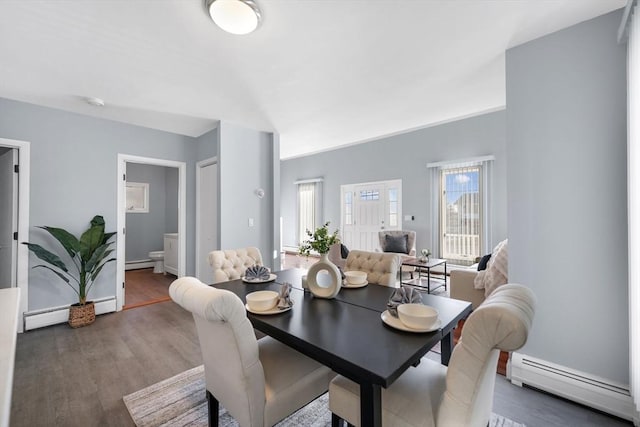 dining area featuring a baseboard radiator and dark hardwood / wood-style floors