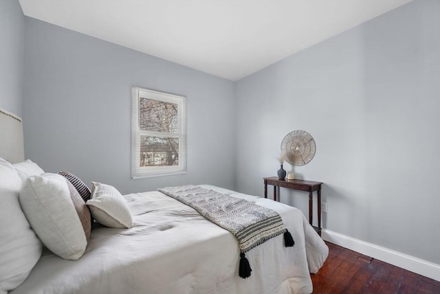 bedroom with dark wood-type flooring