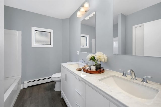 bathroom with hardwood / wood-style floors, a baseboard radiator, vanity, and toilet