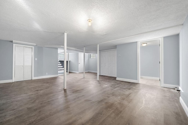 basement featuring a textured ceiling and hardwood / wood-style flooring