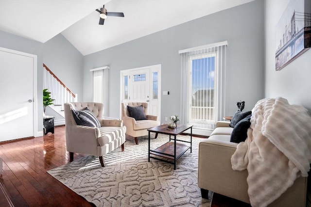 living room featuring ceiling fan, vaulted ceiling, and wood-type flooring