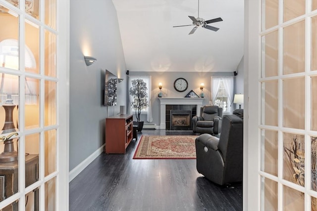 living room featuring baseboards, high vaulted ceiling, a fireplace, dark wood-style flooring, and ceiling fan