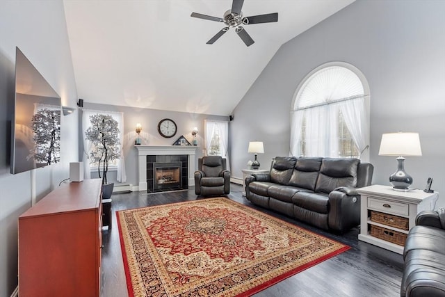 living room with a ceiling fan, a fireplace, dark wood-style flooring, and high vaulted ceiling