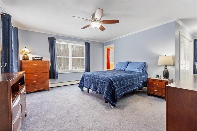 carpeted bedroom with baseboard heating, ceiling fan, and ornamental molding