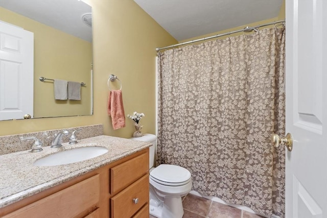 bathroom featuring tile patterned flooring, toilet, and vanity