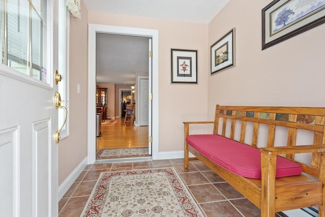 interior space featuring tile patterned floors and baseboards