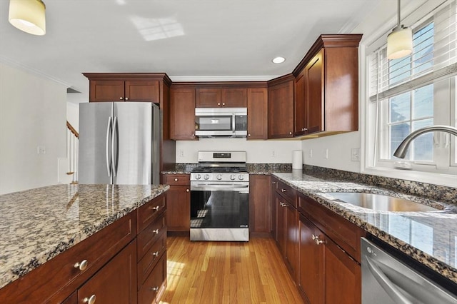 8 School St Unit 1, Waltham, MA 02452 - kitchen with appliances with stainless steel finishes, a sink, light wood-type flooring, ornamental molding, and dark stone counters