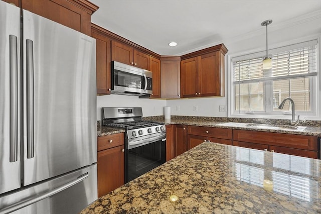 8 School St Unit 1, Waltham, MA 02452 - kitchen with appliances with stainless steel finishes, a sink, dark stone countertops, decorative light fixtures, and recessed lighting