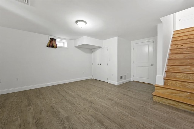 8 School St Unit 1, Waltham, MA 02452 - basement featuring wood finished floors, stairs, and baseboards