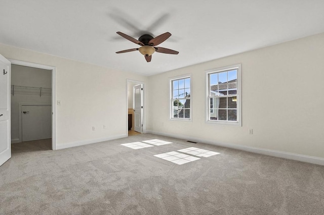 8 School St Unit 1, Waltham, MA 02452 - unfurnished bedroom featuring baseboards, carpet floors, a spacious closet, and a ceiling fan