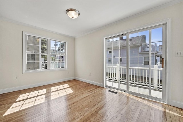8 School St Unit 1, Waltham, MA 02452 - spare room with crown molding, wood finished floors, and baseboards