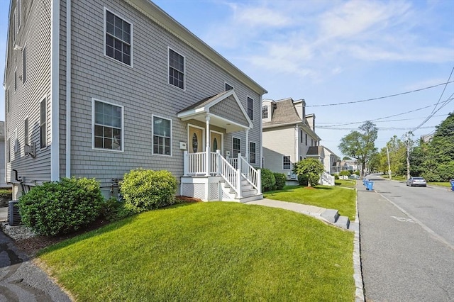 8 School St Unit 1, Waltham, MA 02452 - view of front facade with a front lawn, central AC, and a residential view