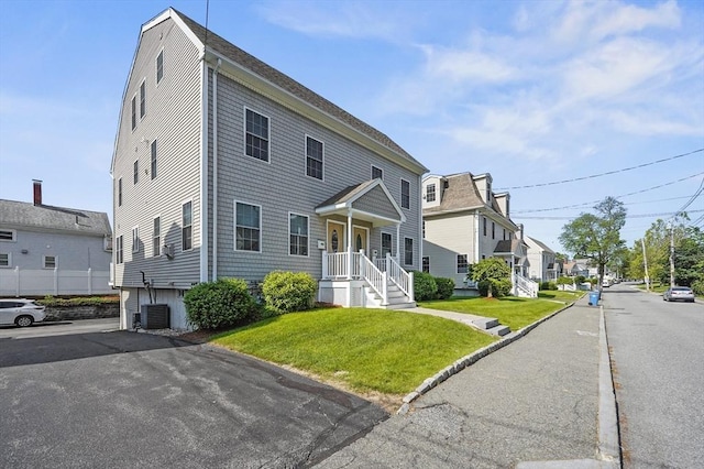8 School St Unit 1, Waltham, MA 02452 - view of front of house featuring a front yard, a residential view, and central AC