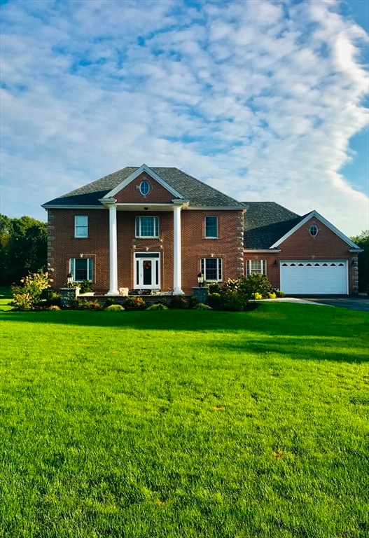 view of front facade with a garage and a front lawn