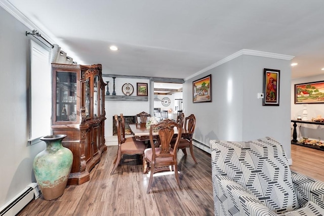 dining space with baseboard heating, wood finished floors, and ornamental molding