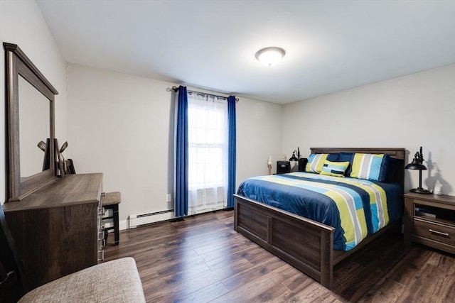 bedroom featuring wood finished floors and a baseboard radiator