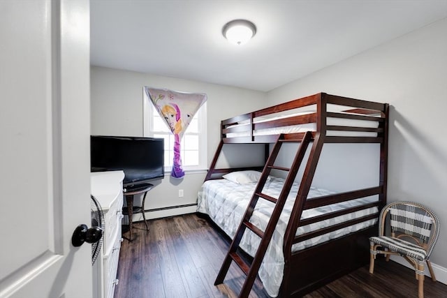 bedroom with baseboard heating, baseboards, and wood-type flooring