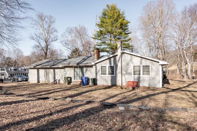 rear view of property with a chimney