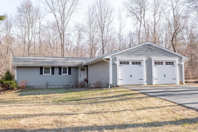 ranch-style home with driveway, a front lawn, and a garage